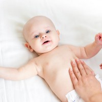 26013510 - mother massaging her baby